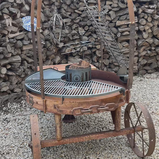 Alamo 120 cart grill in rust: the solid griddle, the vertical spit, the cross grill and the ember basket dropping into their mounts