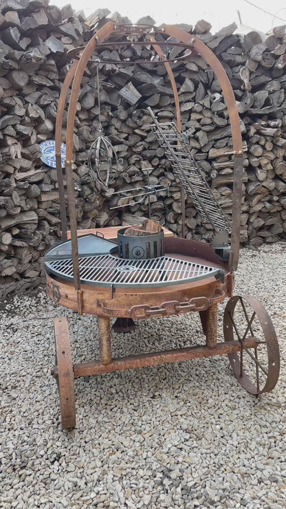 Alamo 120 cart grill in rust: the solid griddle, the vertical spit, the cross grill and the ember basket dropping into their mounts