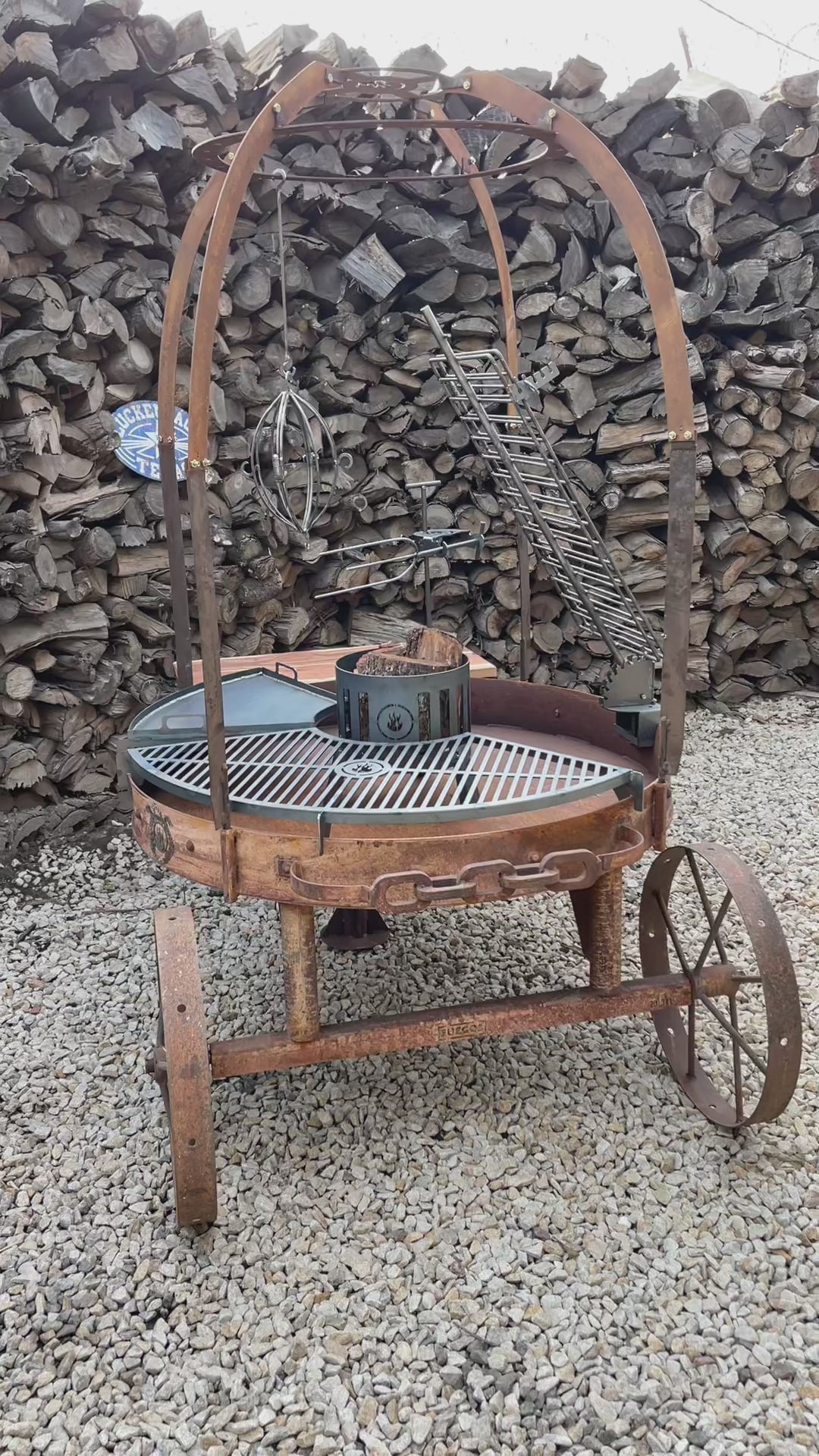 Alamo 120 cart grill in rust: the solid griddle, the vertical spit, the cross grill and the ember basket dropping into their mounts