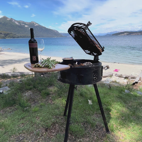 Cowboy portable grill cooking over live fire